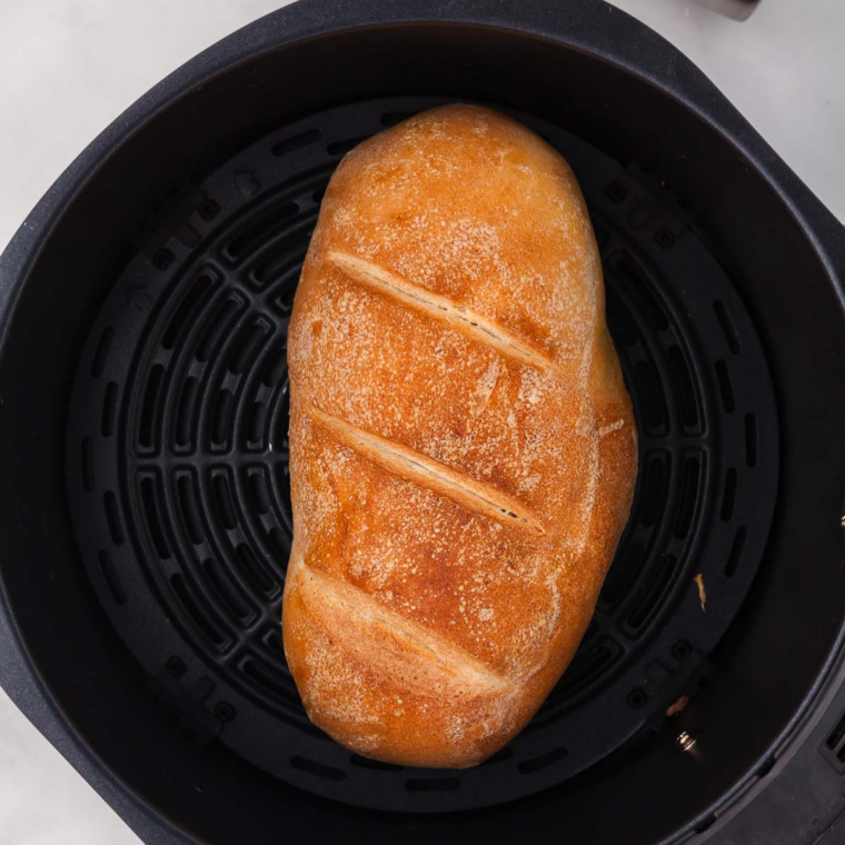 Copycat Longhorn Steakhouse bread sliced open to show its soft honey wheat crumb with whipped butter on the side