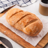 Longhorn Steakhouse bread recipe — two golden honey wheat loaves with grain topping in a bread basket