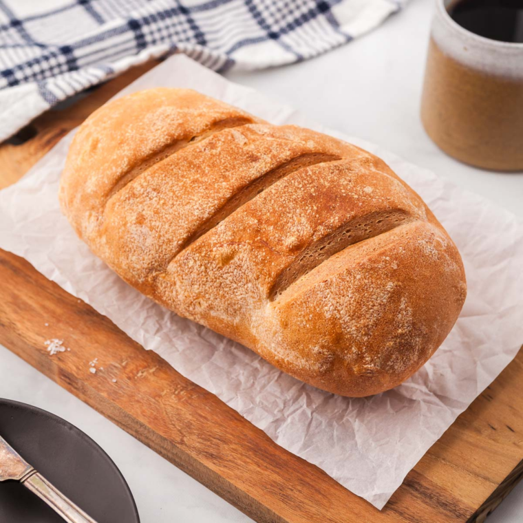 Longhorn Steakhouse bread recipe — two golden honey wheat loaves with grain topping in a bread basket