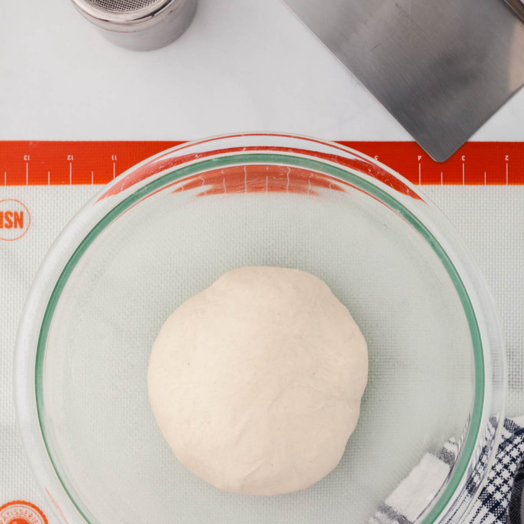 Mixing whole wheat flour, honey, and yeast mixture into a shaggy bread dough