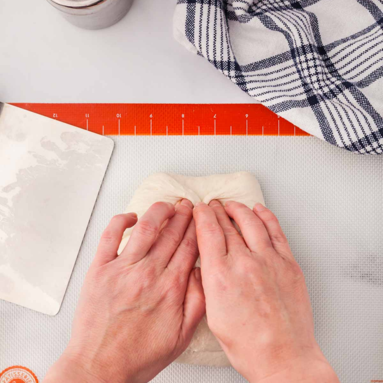 Longhorn bread dough doubled in size after rising in an oiled bowl covered with a towel