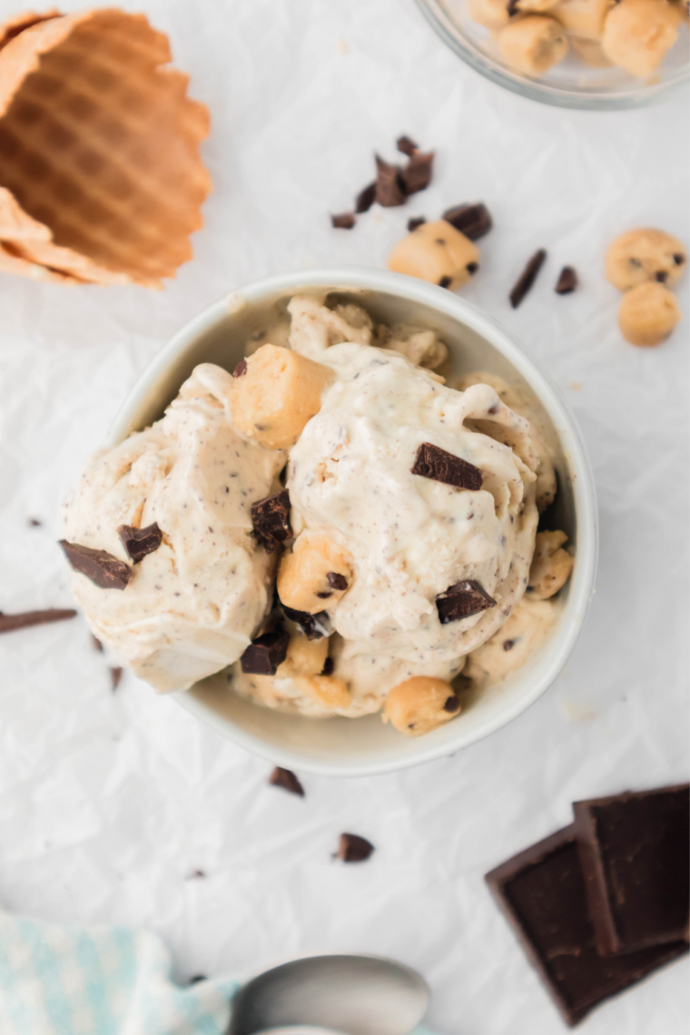 Thick Ninja Creami chocolate chip cookie dough blizzard being scooped from a Ninja Creami pint container
