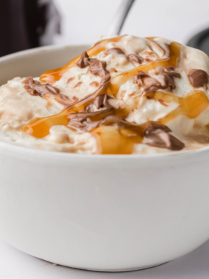 Ninja Creami Moo-llennium Crunch copycat ice cream in a pint with caramel, dark chocolate chunks, pecans, almonds, and walnuts