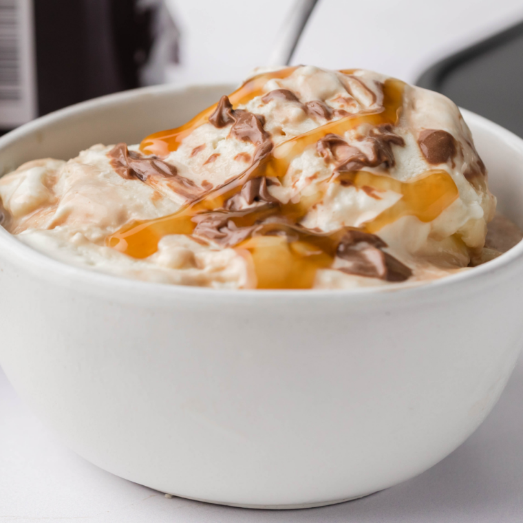 Ninja Creami Moo-llennium Crunch copycat ice cream in a pint with caramel, dark chocolate chunks, pecans, almonds, and walnuts