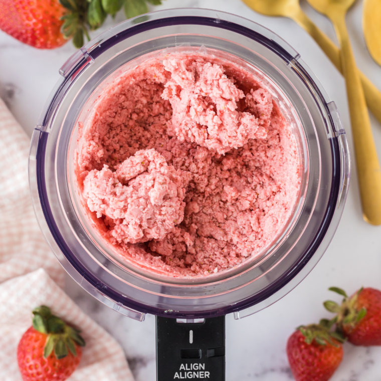 Crumbly strawberry ice cream in a Ninja Creami pint after the first ICE CREAM spin