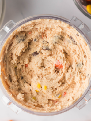 Ninja Creami Dairy Queen Reese's Blizzard in a cup topped with chopped Reese's cups and peanut butter drizzle