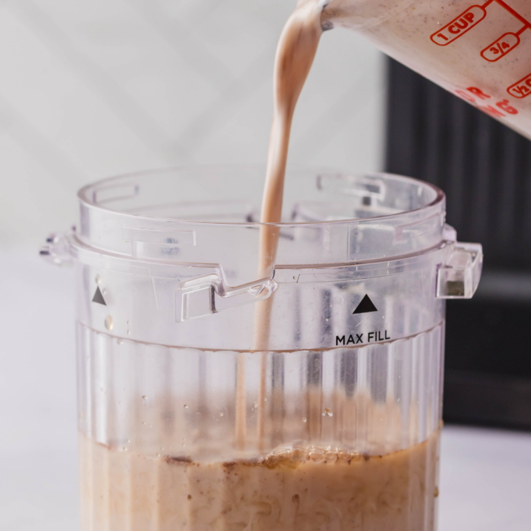 Coffee, milk and sugar stirred together in a Ninja Creami pint container before freezing