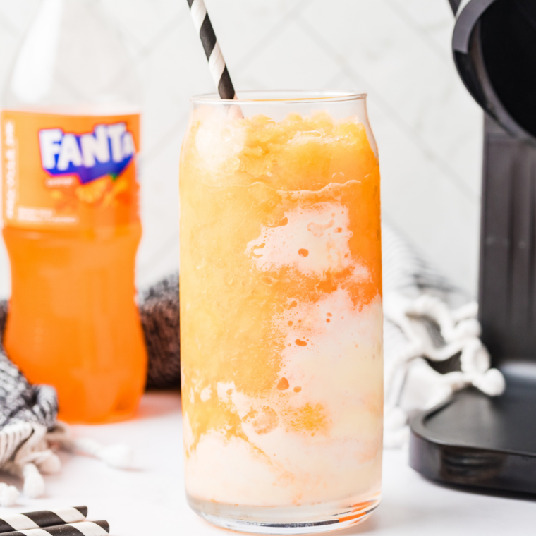 Finished Fanta float slushie with a straw and spoon