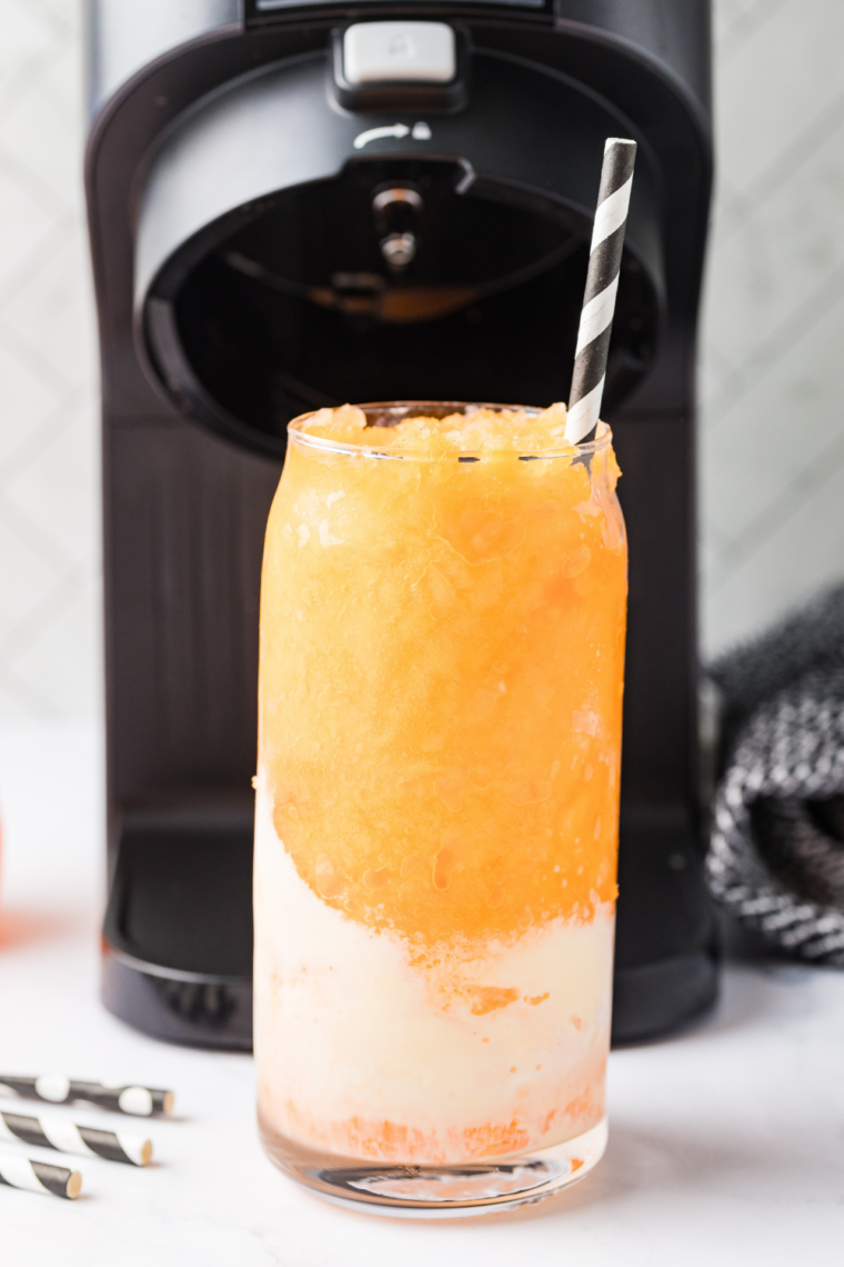 Ninja Creami Fanta Float Slushie in a tall glass topped with vanilla ice cream