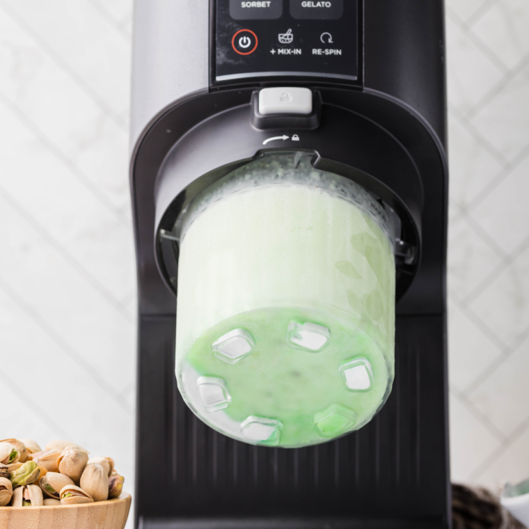 Frozen pistachio base locked into the Ninja Creami on the ice cream setting