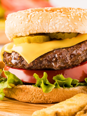 Two juicy cheeseburgers with melted American cheese on toasted buns, made with the Ninja Crispi burger recipe