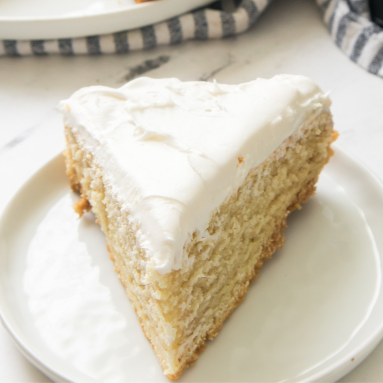 Sliced white cake on a wooden cutting board, baked in the Ninja Crispi