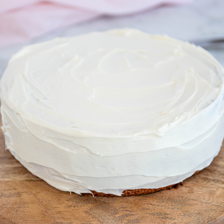 Baked vanilla cake inverted onto a wire rack with the parchment peeled off