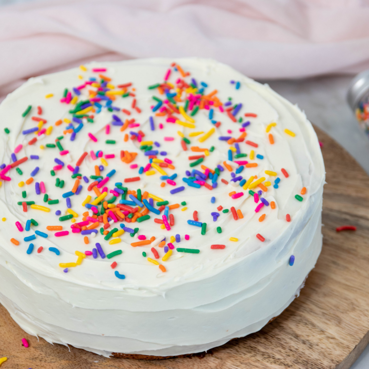 Whole Ninja Crispi cake with white frosting and rainbow sprinkles