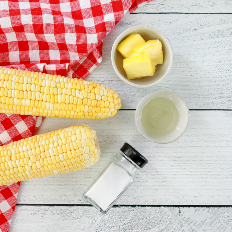Ingredients for Ninja Crispi corn on the cob: fresh sweet corn, olive oil, salt, pepper, and butter
