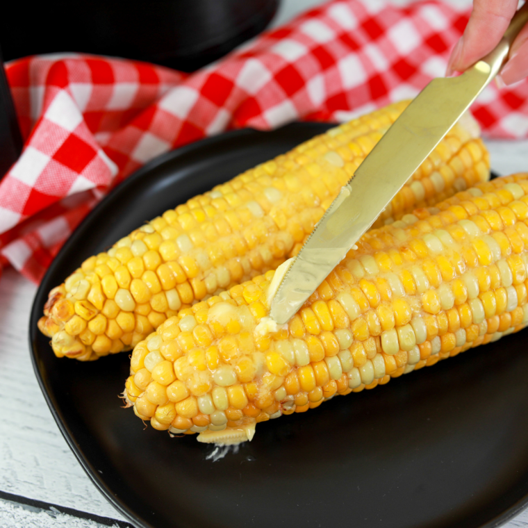 Ninja Crispi corn on the cob served alongside crispy sweet potato fries