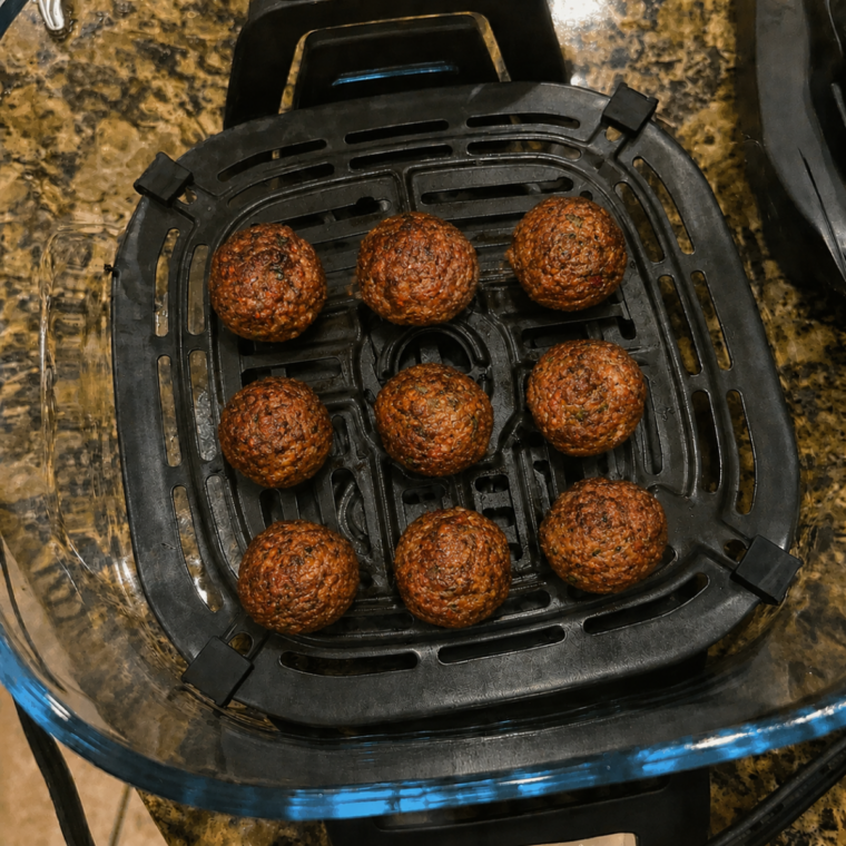 Meatballs browning under the Ninja Crispi PowerPod partway through the 12-minute cook time