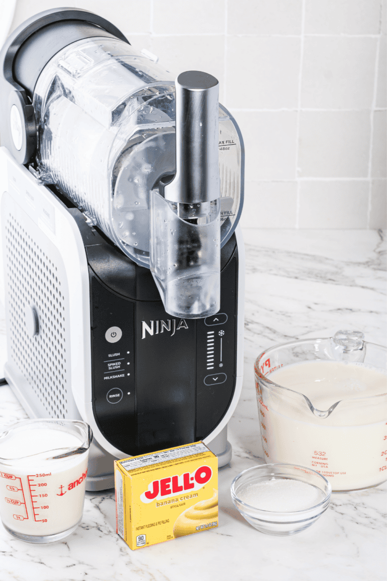 Pouring banana milkshake mixture into the Ninja Slushi vessel