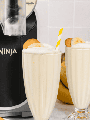 Ninja Slushi Banana Milkshake topped with whipped cream and banana slices