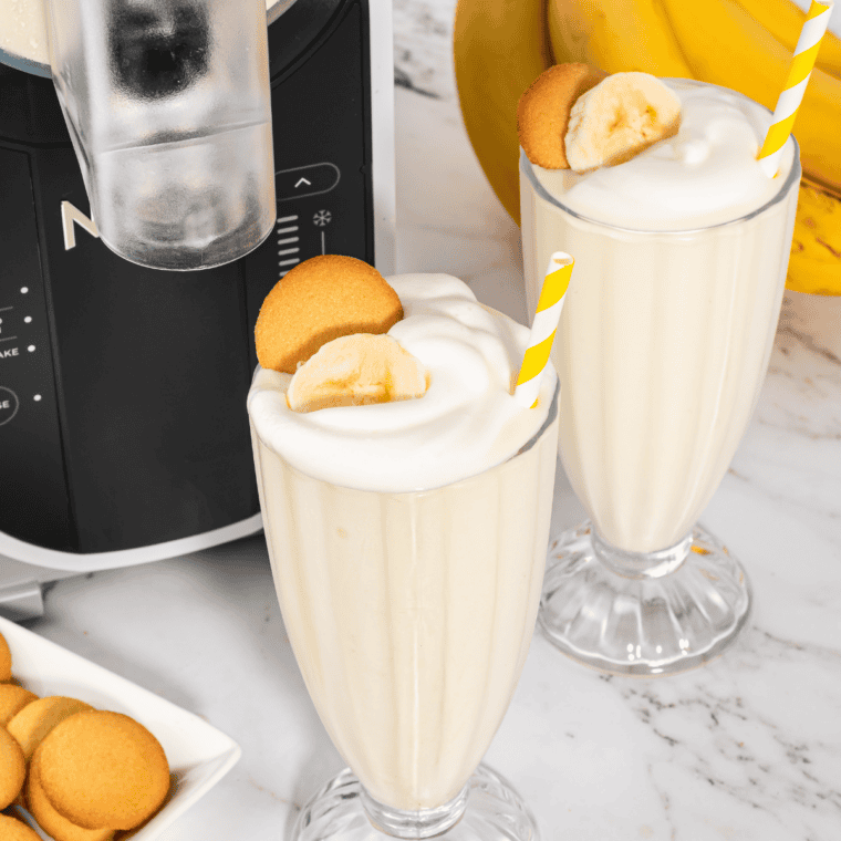 Creamy Ninja Slushi banana milkshake topped with whipped cream and banana slices