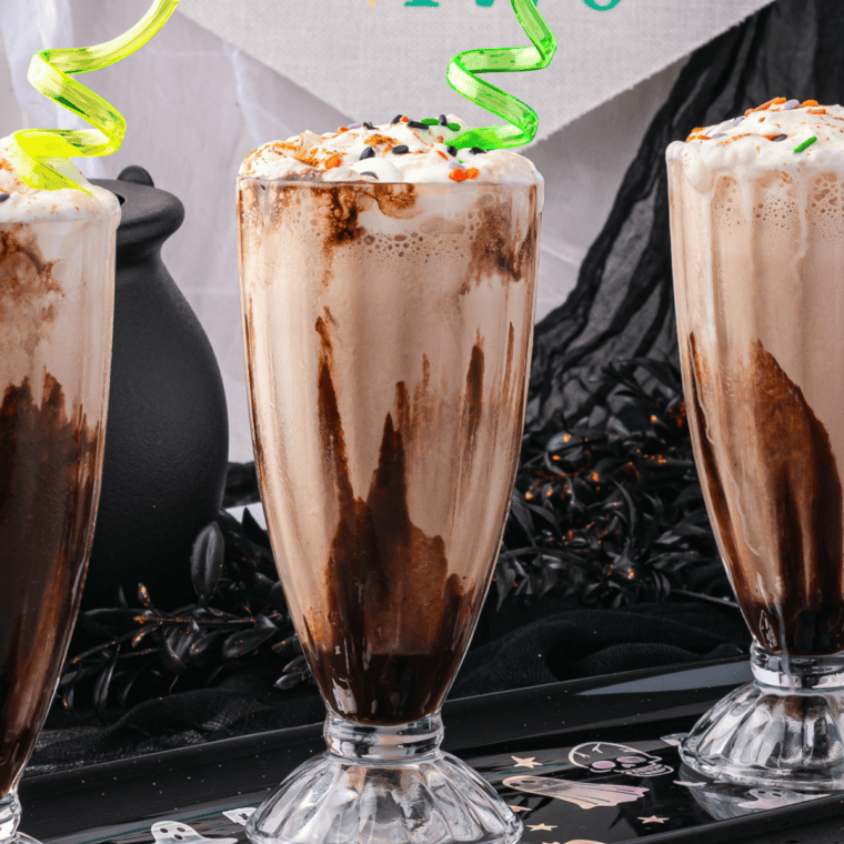 Two glasses / styled shot: Two Ninja Slushi chocolate milkshakes topped with whipped cream and chocolate shavings