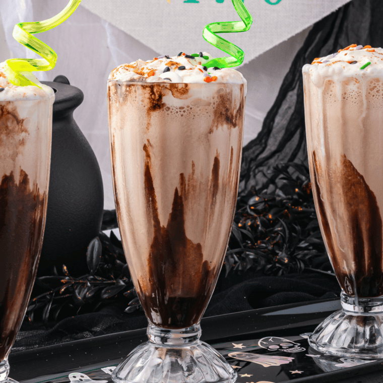 Ninja Slushi chocolate milkshake in a tall glass topped with whipped cream and chocolate syrup