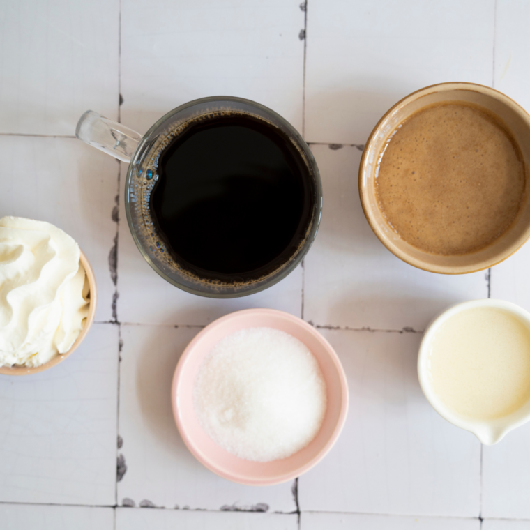 Ingredients for a Ninja Slushi mocha frappe: cold brew, milk, chocolate syrup, simple syrup, and vanilla