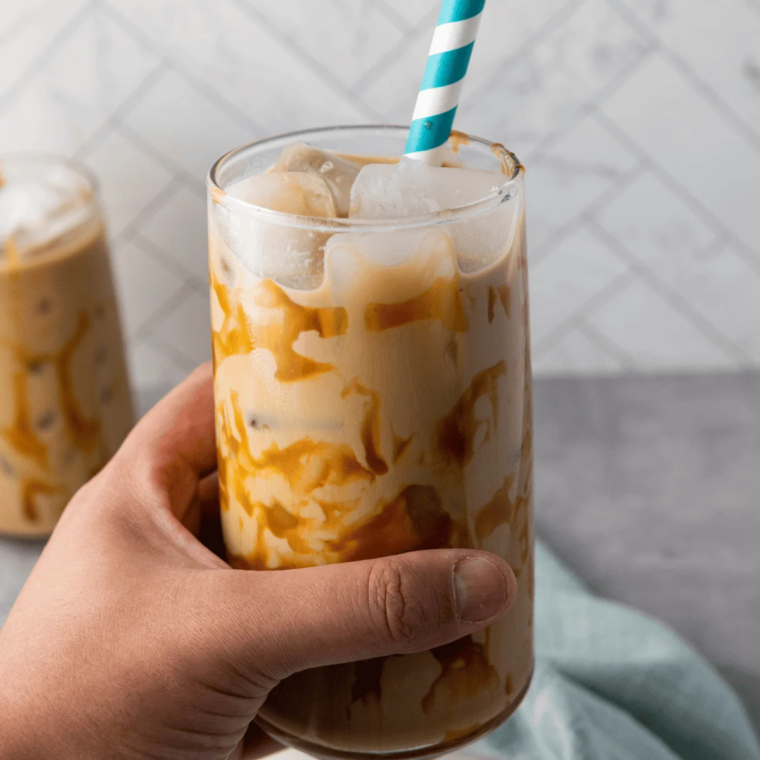 Homemade Ninja Slushi mocha frappe next to a McDonald's cup showing lower calories and cost