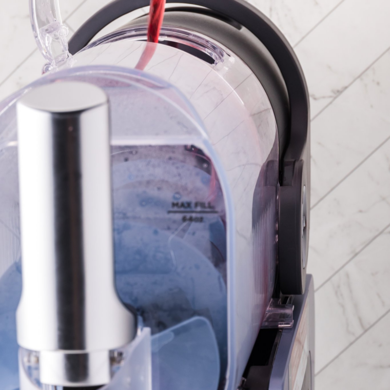 Pouring the Orange Julius base into the Ninja Slushi vessel below the max fill line