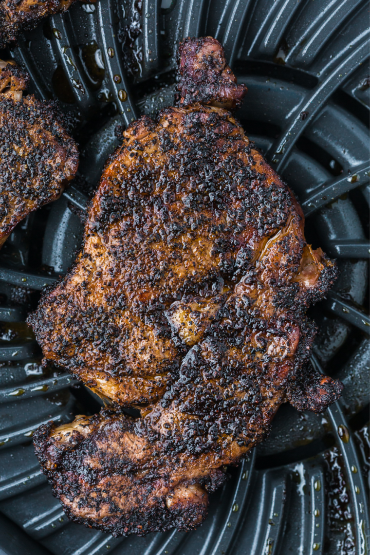 Close-up of a juicy Outlaw Ribeye steak sliced to show the pink medium-rare interior and crust