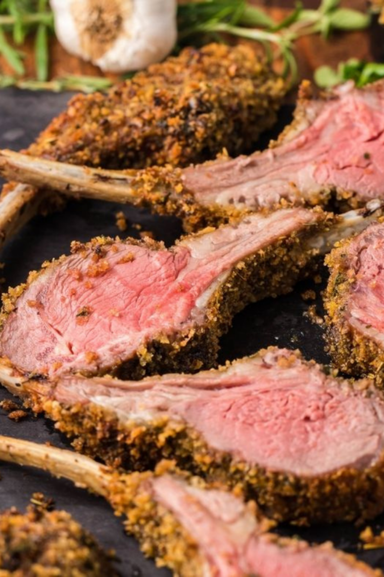 Parmesan crusted lamb chops with a golden panko crust on a white plate