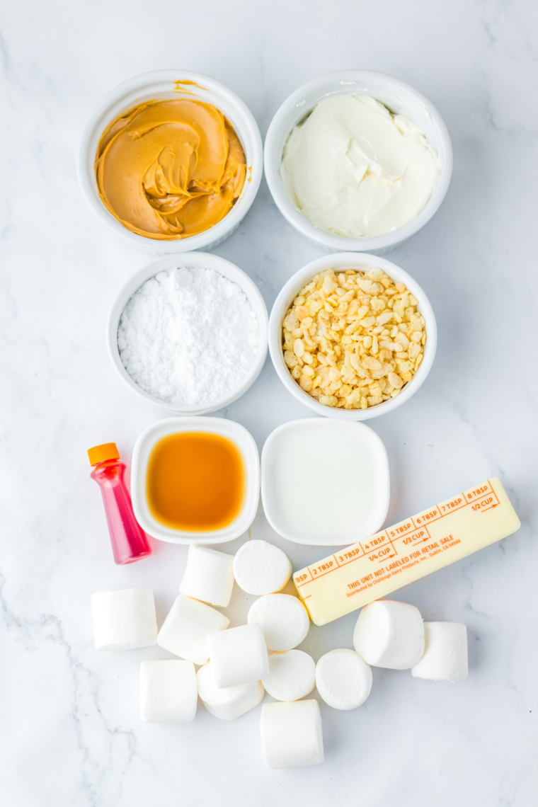 Ingredients for pumpkin pie Rice Krispie treats including butter, marshmallows, cereal, cream cheese, powdered sugar, and peanut butter