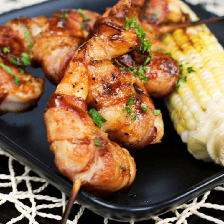 Cooked shrimp coated in Red Lobster Cajun seasoning in an air fryer basket