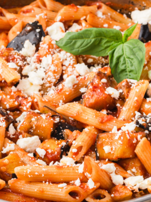 Roasted tomato pasta sauce in a white bowl topped with fresh basil and grated parmesan