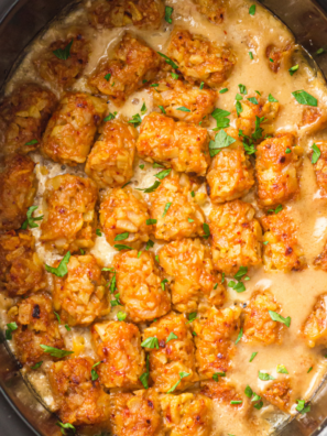 Slow cooker cowboy casserole topped with crispy golden tater tots and melted cheddar cheese