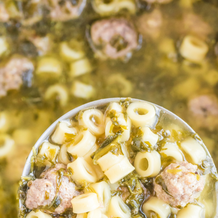 Bowl of slow cooker Italian wedding soup with chicken meatballs, orzo, and spinach