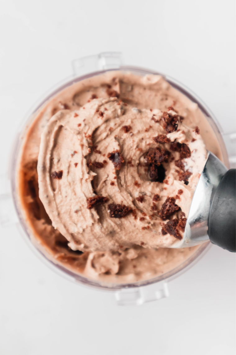 Scoops of Cold Stone Chocolate Devotion Ninja Creami ice cream with brownie chunks and a hot fudge drizzle