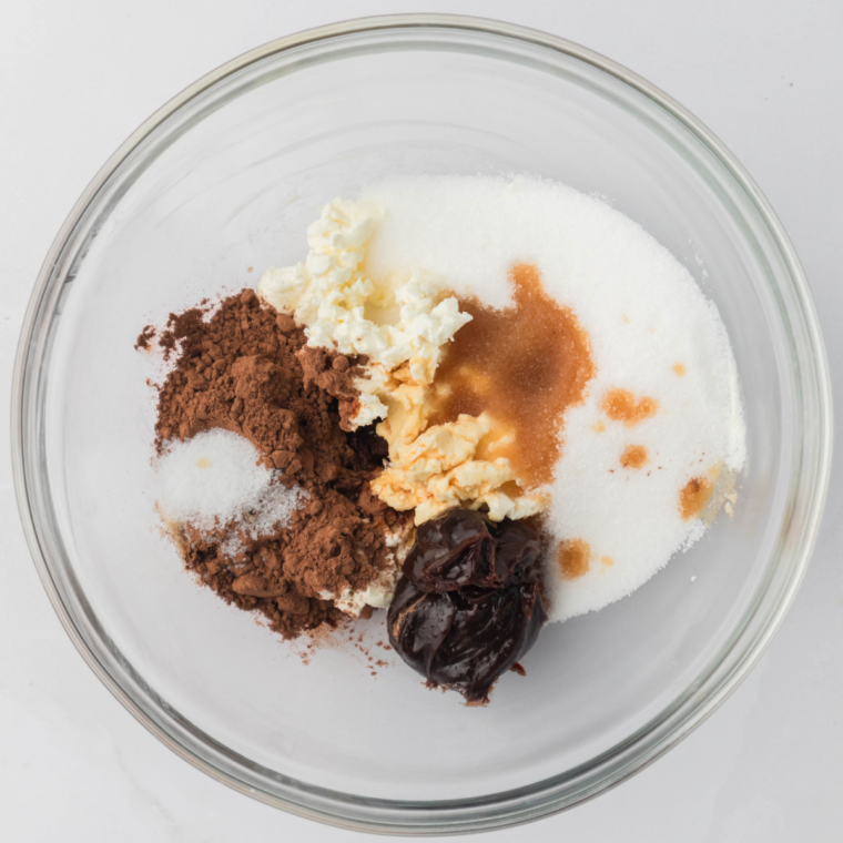 Milk, sugar, cocoa, and chocolate chips warming in a saucepan, whisked into a smooth glossy chocolate base