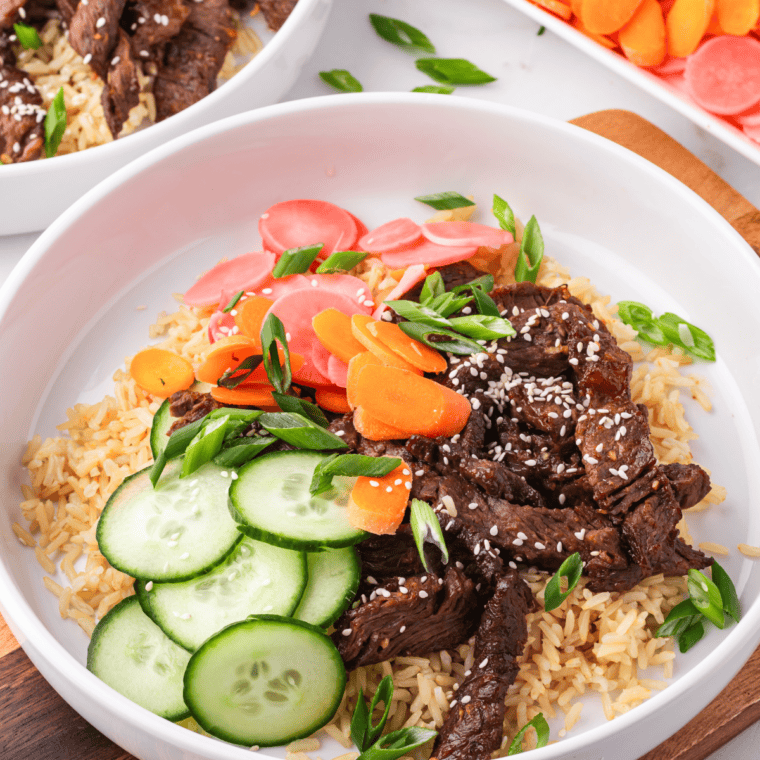 Close-up of caramelized bulgogi beef over rice with sesame seeds