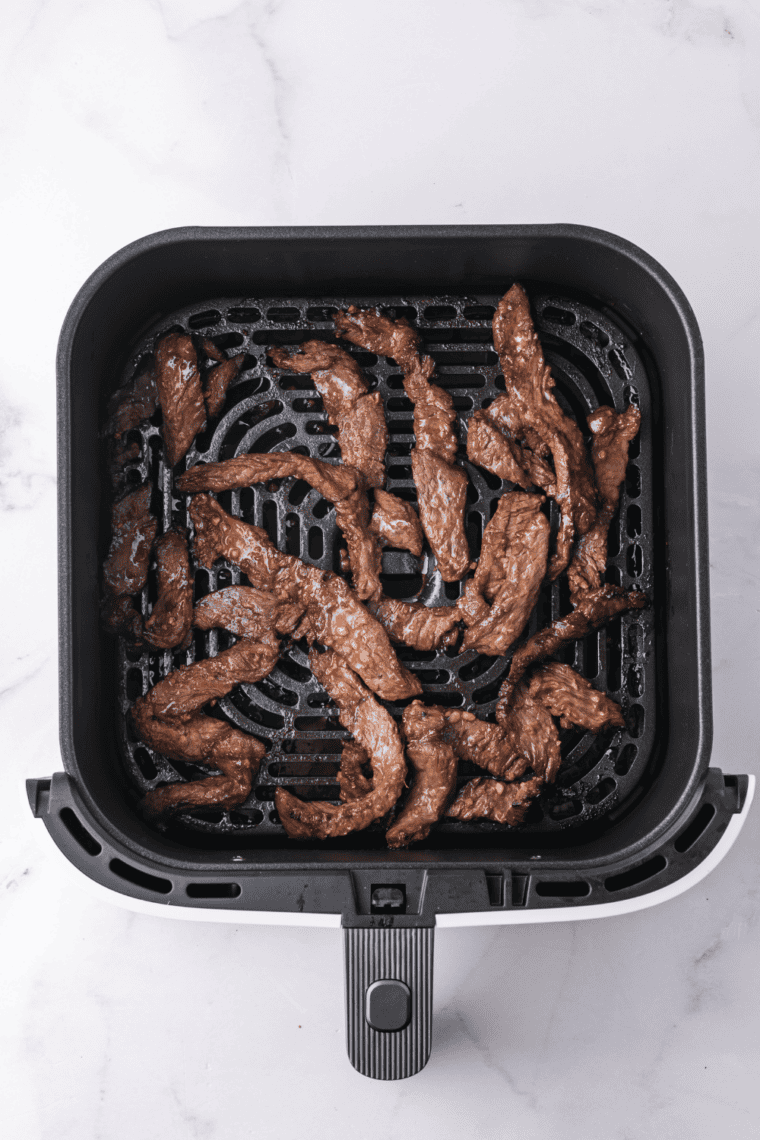 Air-fried bulgogi beef on a plate with crisp, browned edges