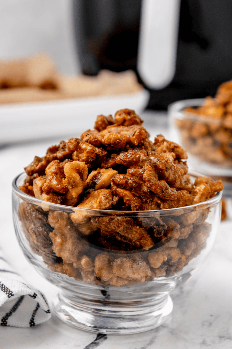 Air fryer candied coffee walnuts served in a small white cup as a snack