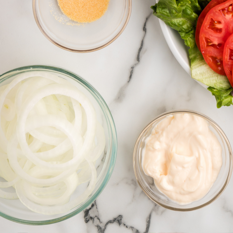 ingredients needed for air fryer copycat French's fried onions on a marble counter