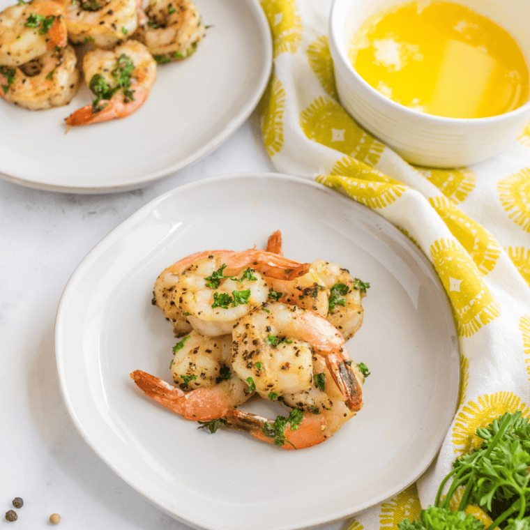 Garlic shrimp seasoned with homemade lemon pepper on a white plate