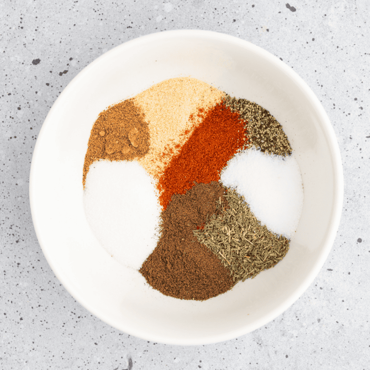 Whisking dry milk powder, flour, and spices together into country gravy mix in a glass bowl