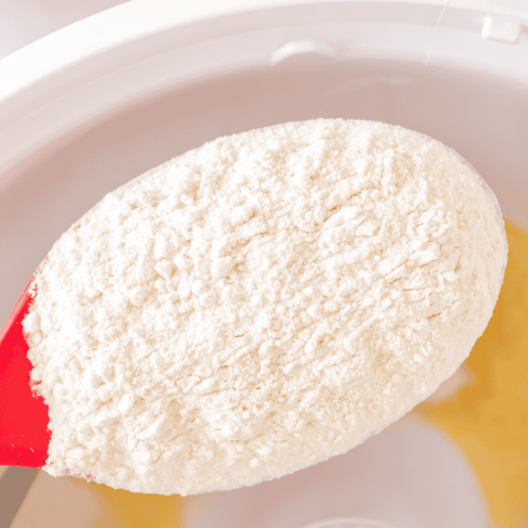 Cheese stick dough kneading on a dough hook in a stand mixer bowl