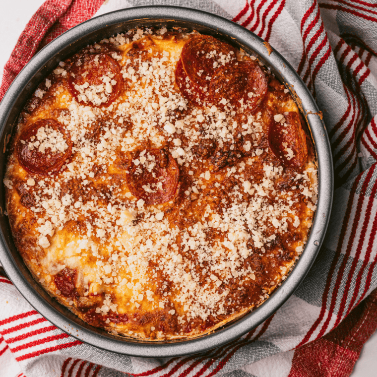 Homemade Pizza Hut style pan pizza in a cast iron skillet with melted cheese and pepperoni