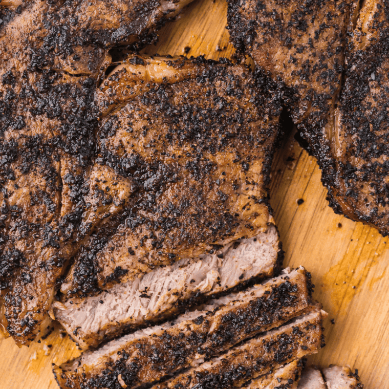 Raw ribeye steak generously coated with homemade Ruth's Chris style steak seasoning