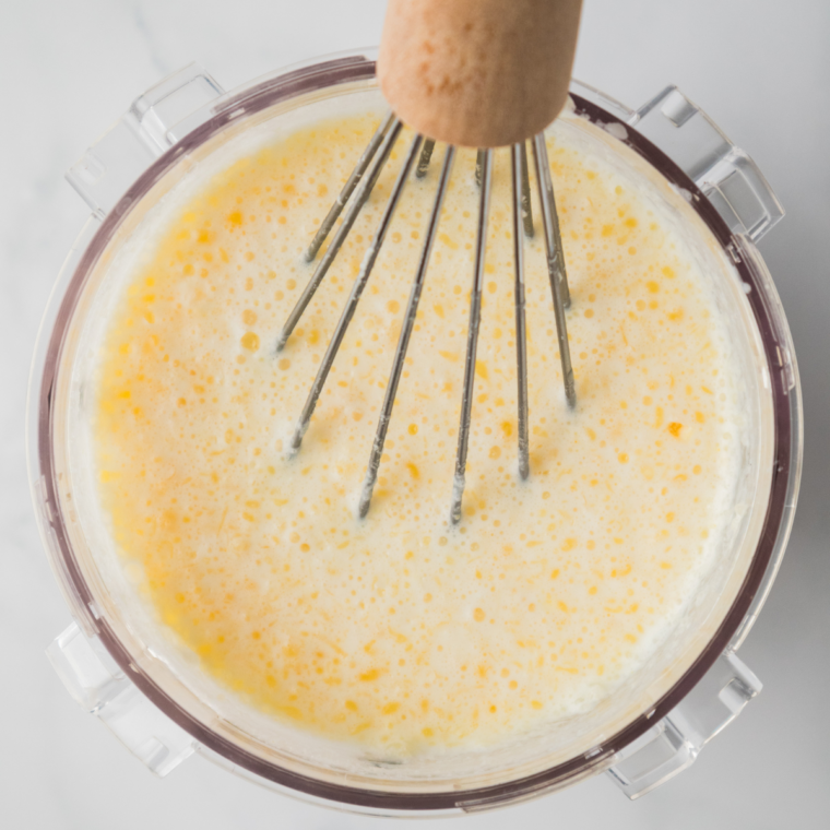 Whisking milk, sweetened condensed milk, and caramel sauce in a large glass bowl until smooth