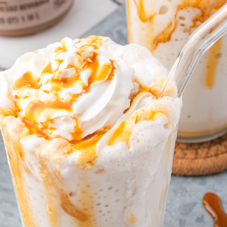 Copycat Wendy's Caramel Crunch Vanilla Frosty Fusion in a clear cup with caramel drizzle and toffee bits on top