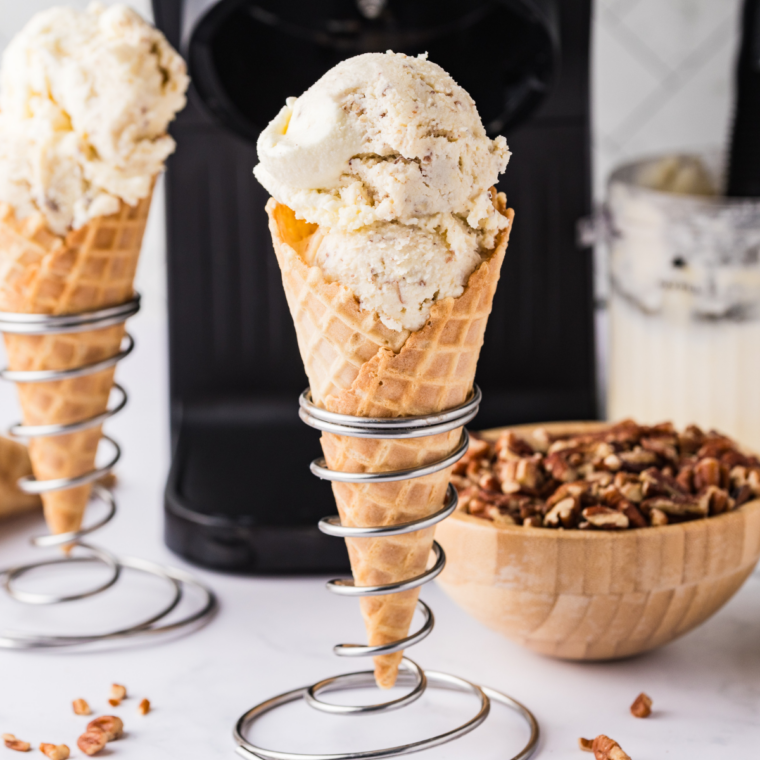 Ninja Creami Copycat Baskin Robbins Old Fashioned Butter Pecan ice cream in a waffle cone with toasted pecans